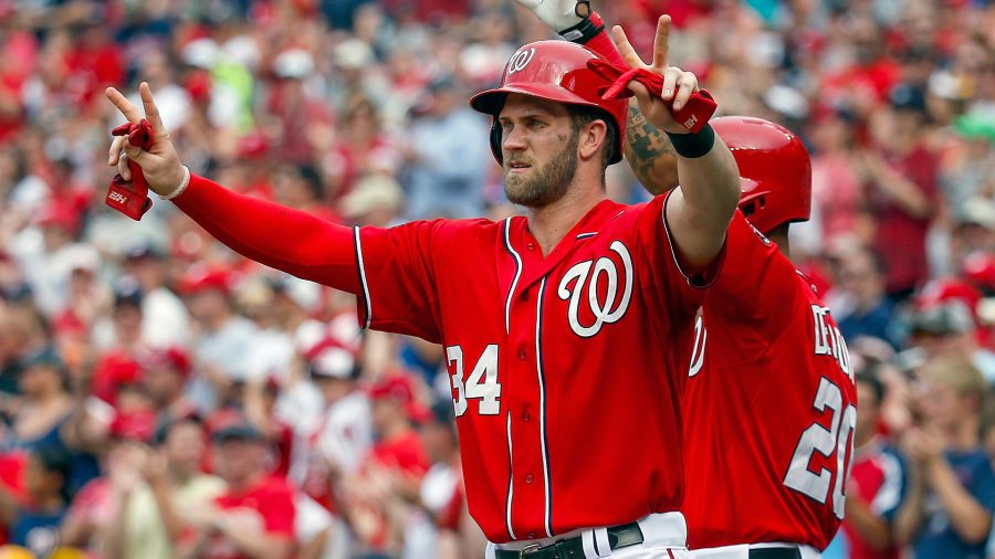 Bryce Harper celebrates with teammates after scoring a run 