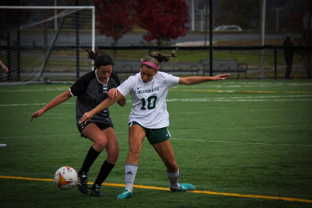 A SECOND CHANCE - Junior girls varsity soccer player Olivia Heinemann battles a Walls player for the ball. After a devastating loss in the city championships, the Tigers must look forward to state’s.