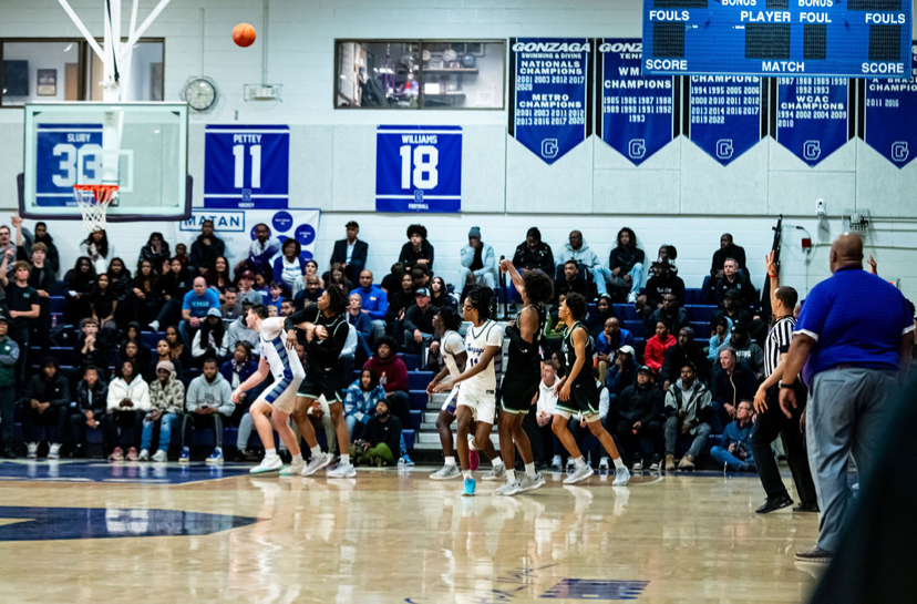 TIGERS ON-COURT: Senior Scottie Hubbard attempting a three point shot against Gonzaga College High School on Dec. 10. 