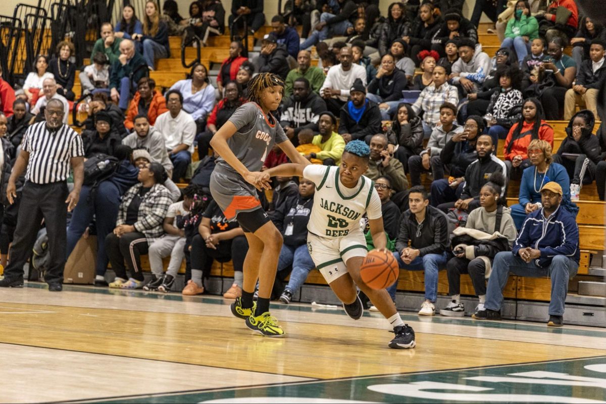 BALL OUT - Senior guard Moxie Coleman-Miller takes the ball down the
court. The girls’ basketball team is headed to the playoffs.