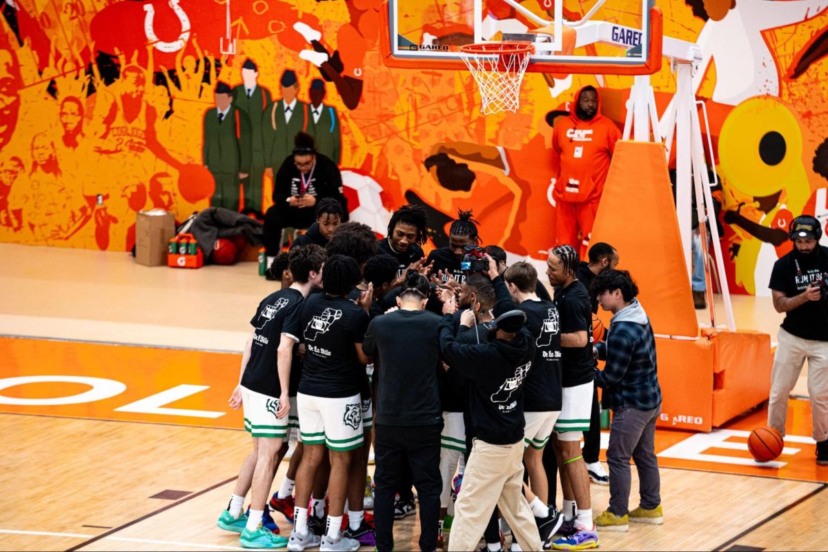 PREGAME HUDDLE: The Tigers huddled pregame ahead of their DCIAA championship game against Cardozo High School from February 17. 