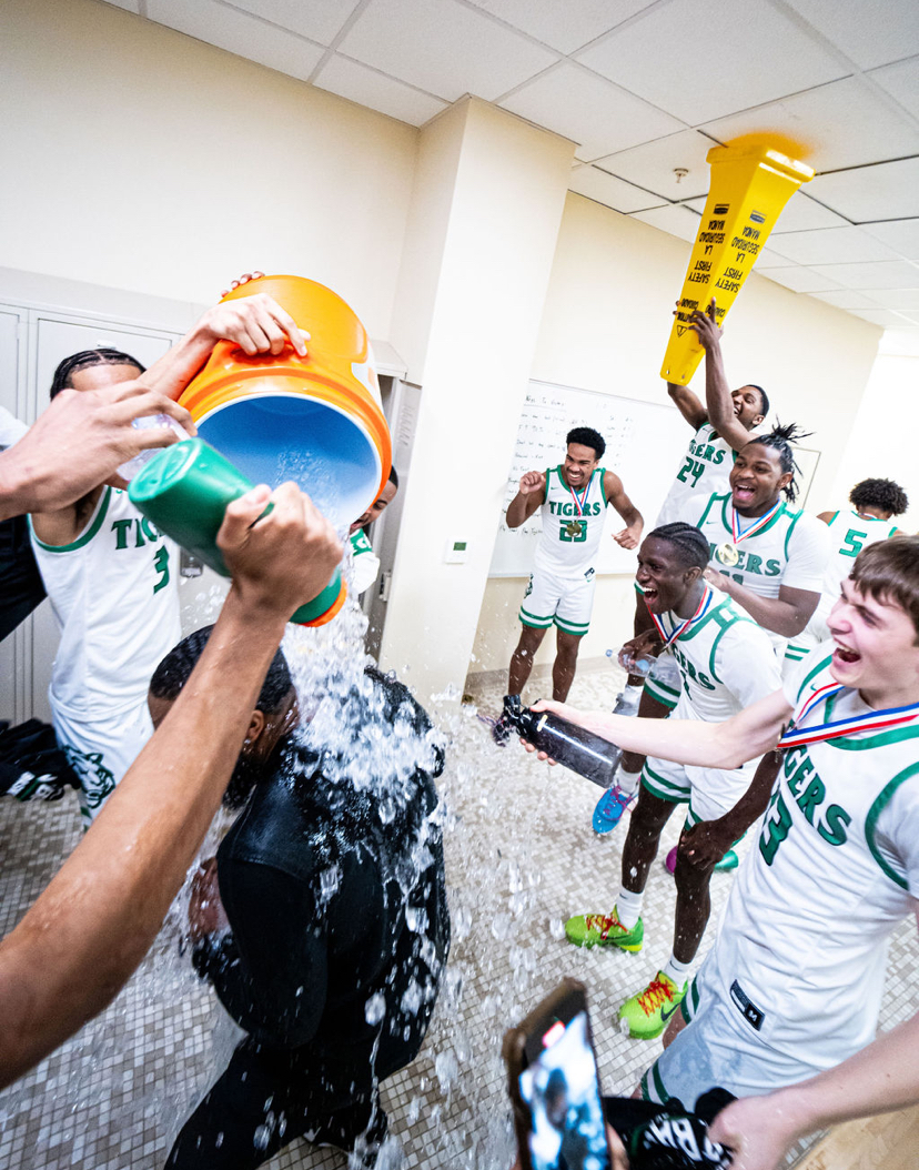 VICTORY BATH: Head coach Tee Johnson getting a gatorade bath in the locker room. 