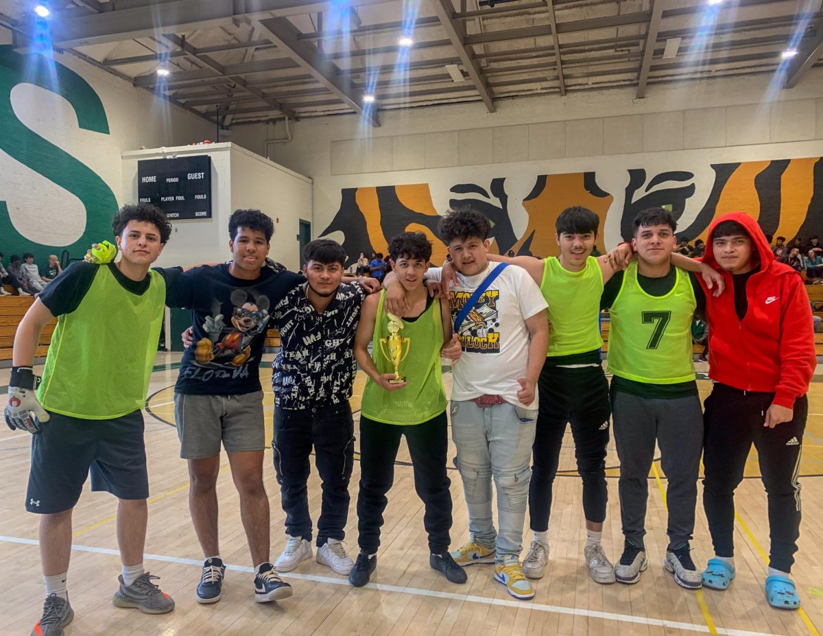 DAPPER DUBS- Olimpia FC poses with the 2024 SGA futsal league trophy. After winning in the student finals, they lost in the students vs. staff game.