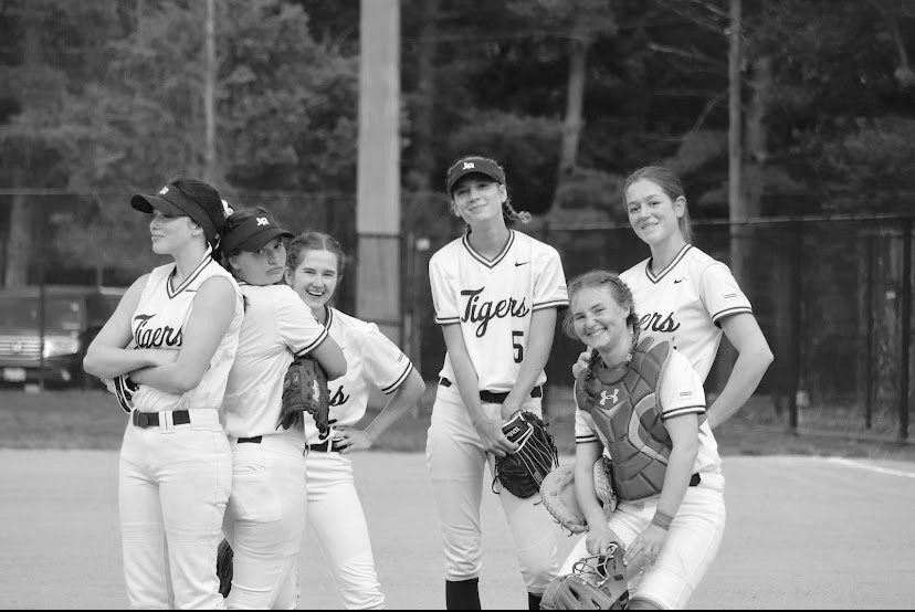 POWER POSE- Six lady tigers pose for the camera in
their softball uniforms. The team won DCIAA finals.