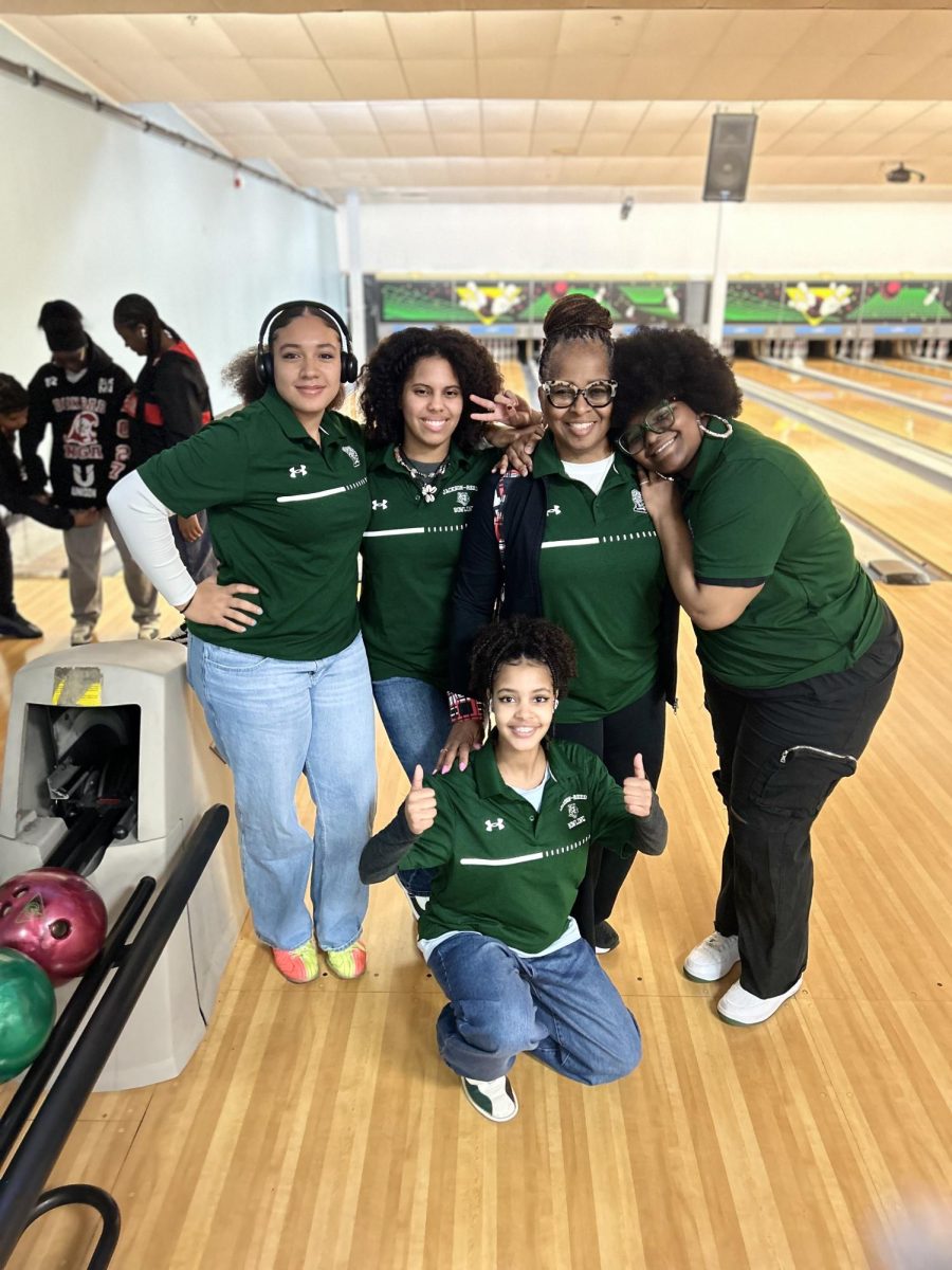 JR BOWLING STRIKES AGAIN- Head bowling coach Rebecca Bradshaw-Smith and the team pose at the bowling lanes. This is the 12th year a bowling team has been hosted at JR.