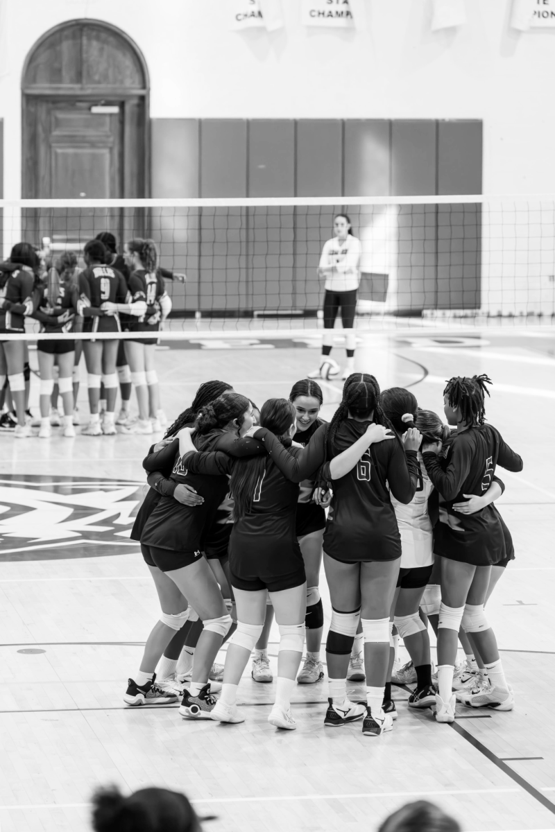 MIGHTY MIGHTY TIGERS - The first JV volleyball team since pre-pandemic huddles up before their game.