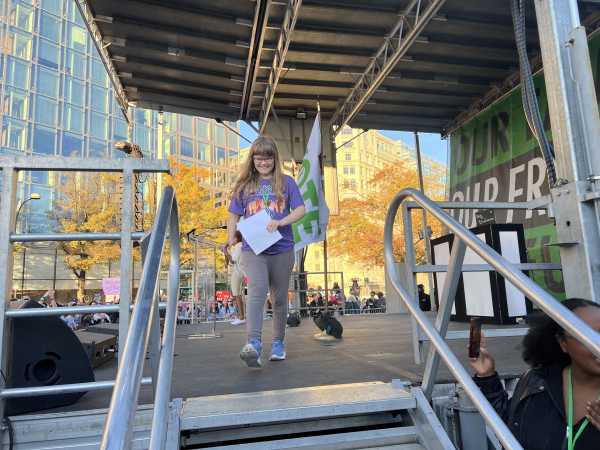 SMILING ON STAGE - Edie Young walks off stage after speaking at the Women's March on November 2nd. In her speech, Young discusses topics such as abortion rights and trans rights. 