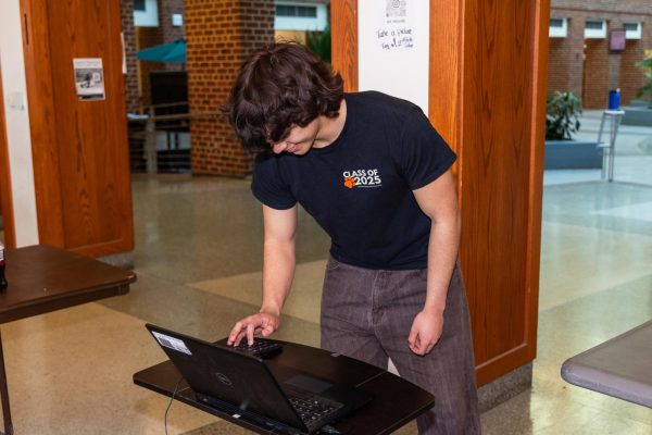 NO MORE FREES? - A senior signs out to leave the building during his free period. Next year, this sighting may be more rare.