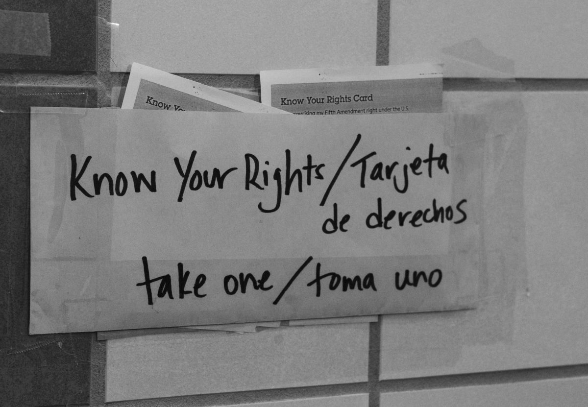 TARJETA DE DERECHOS - An envelope filled with "Know Your Rights Cards" hangs outside of room 210.