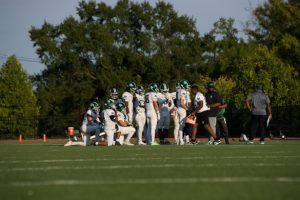RECRUITING DIFFICULTY - The Tigers offense huddled together in their game against the St. Albans School on September 14. 